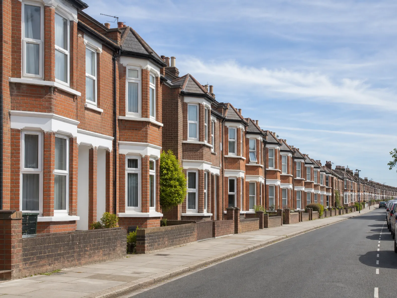 A long street of Victorian bay-fronted red-brick terraced houses in inner Southampton